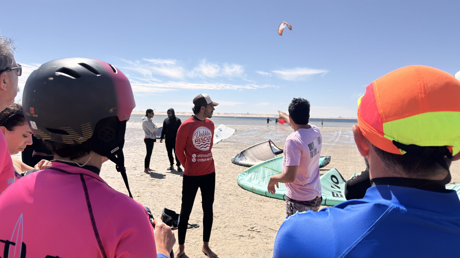 Two surf instructors with boards on Dakhla beach